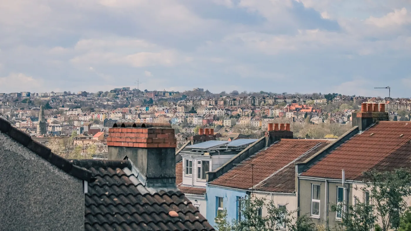 Pitched roofs and chimneys of terraced houses seen from above