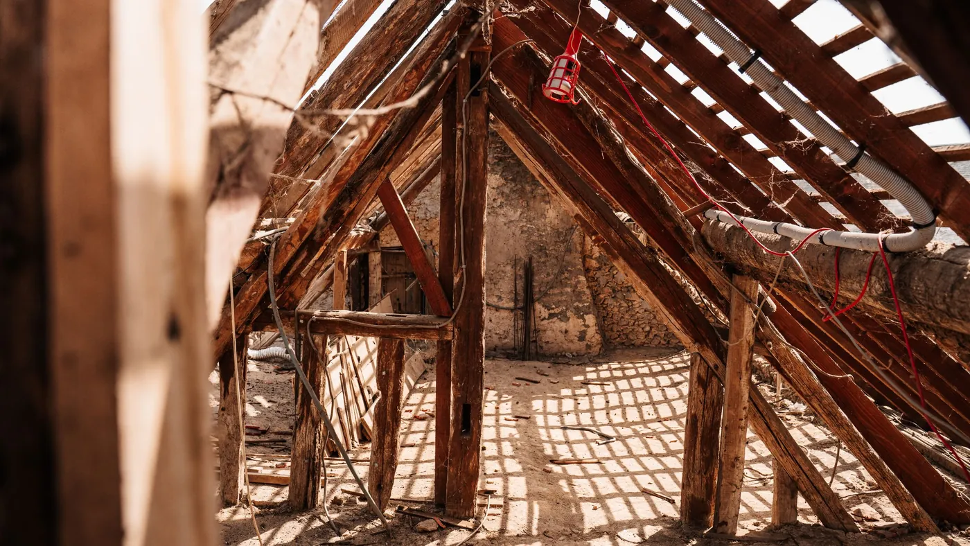 Timber roof rafters and struts inside an unconverted loft space