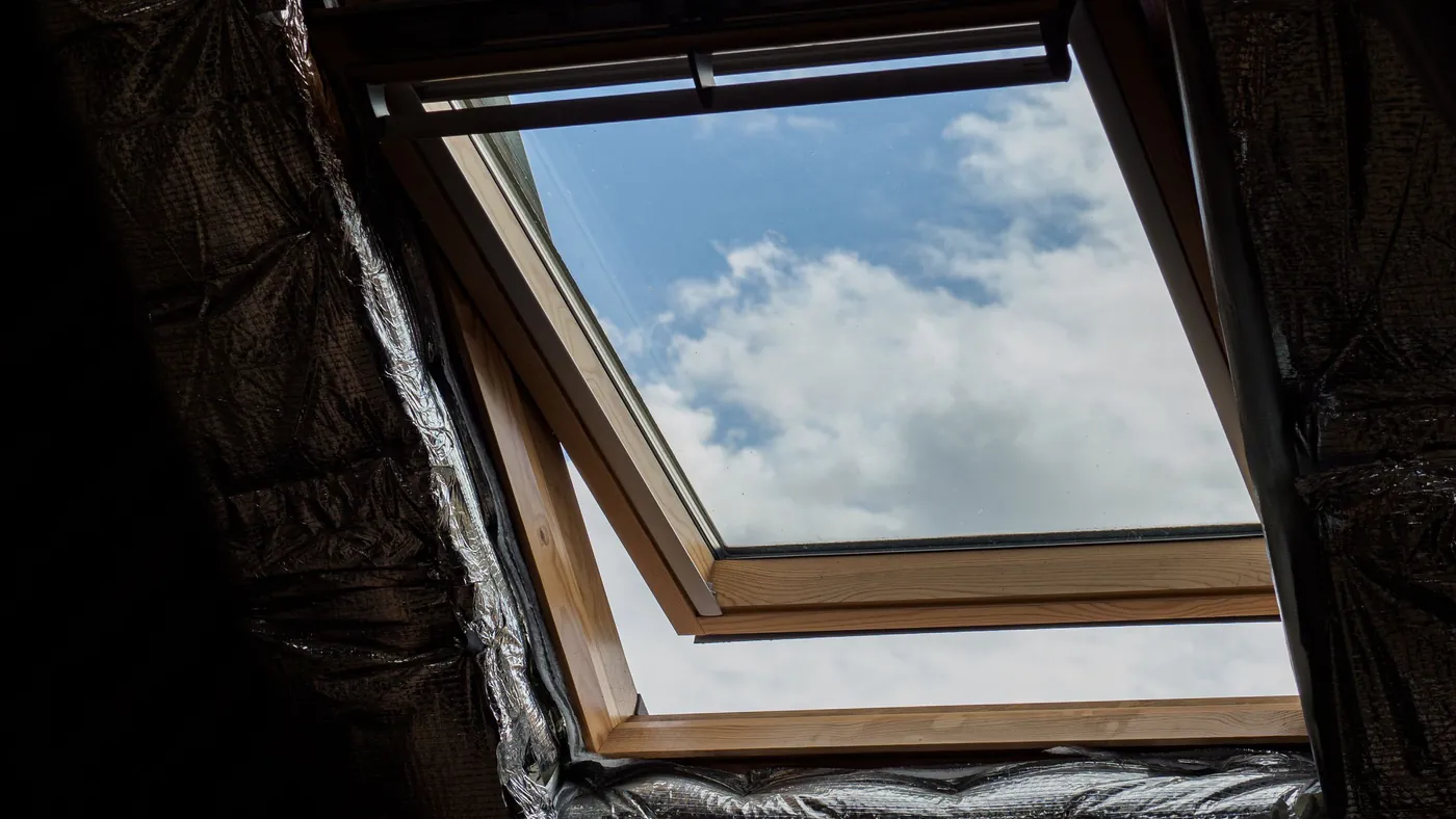 Open rooflight window set into a sloping loft ceiling