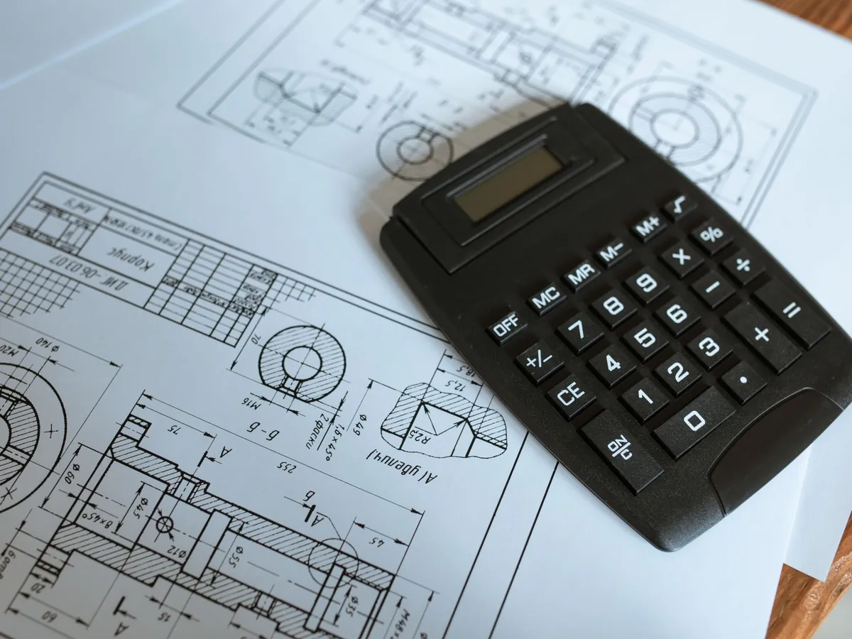 Calculator and printed drawings used to price building work