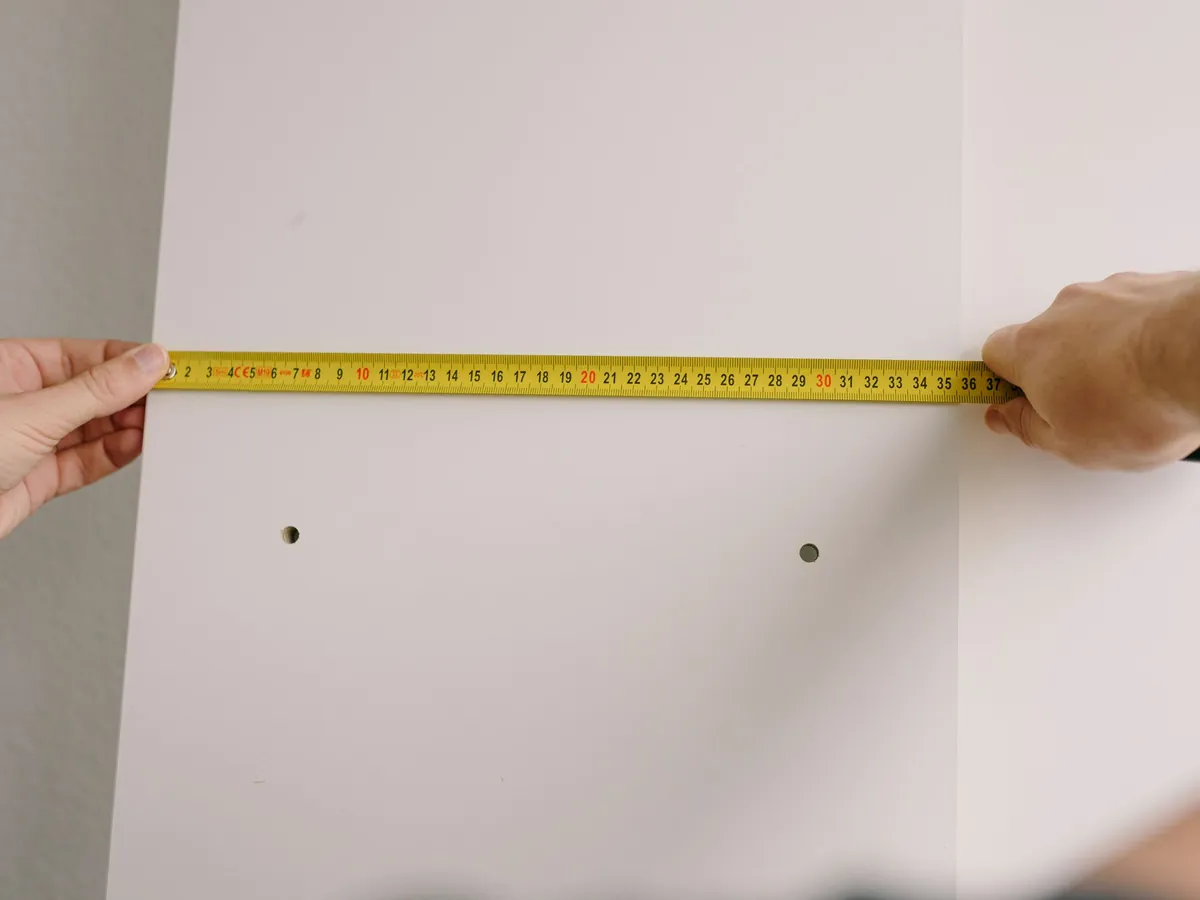 Tradesman measuring and marking a wall