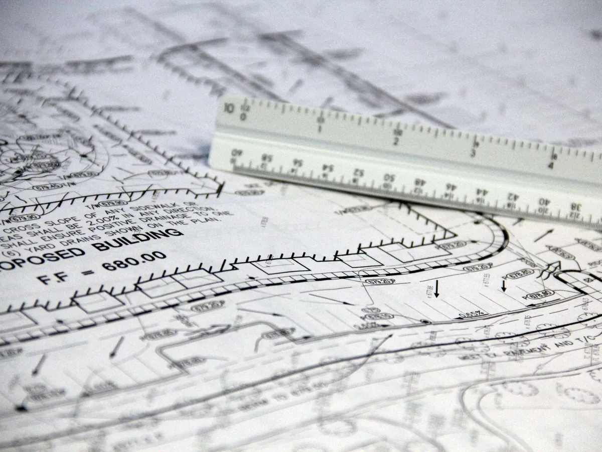 Construction drawings and a scale rule on a desk