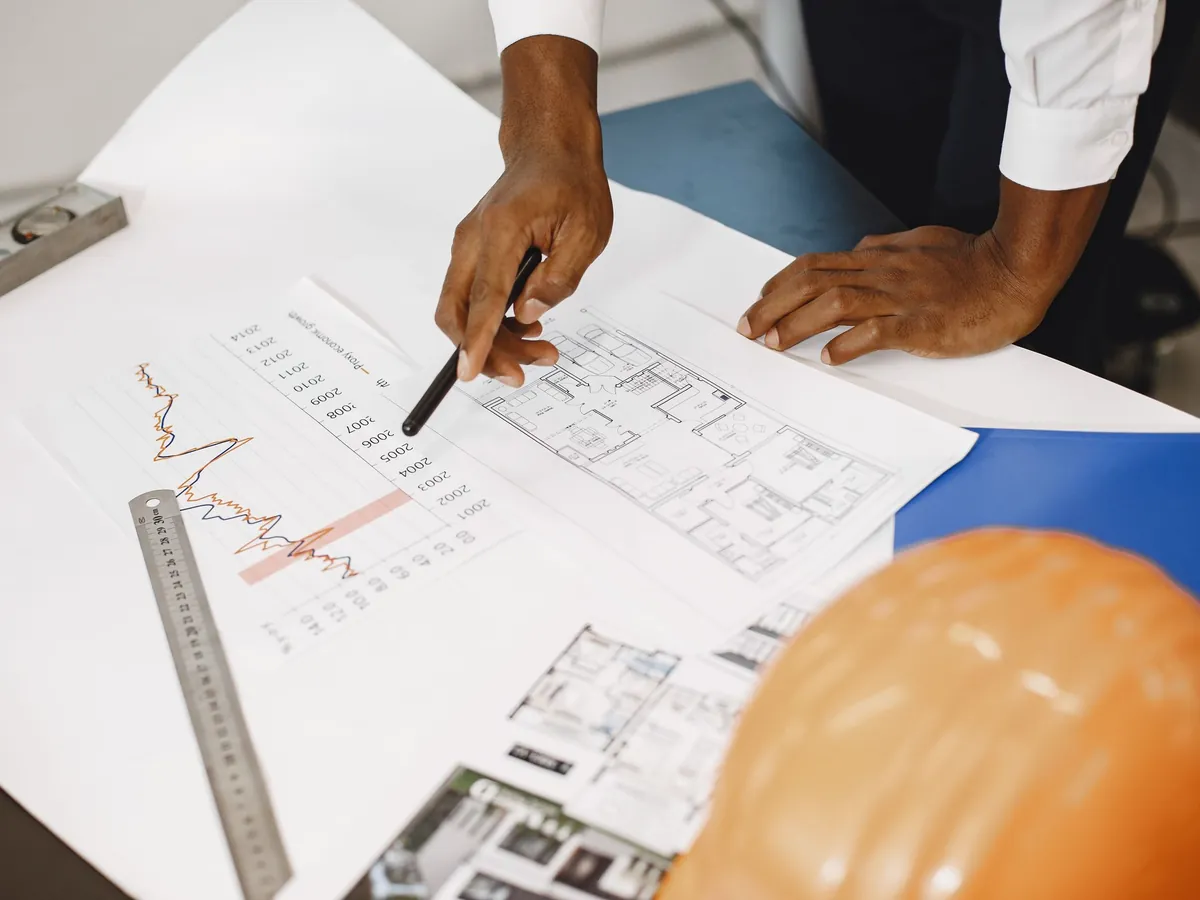 Plans and cost figures being reviewed at a desk